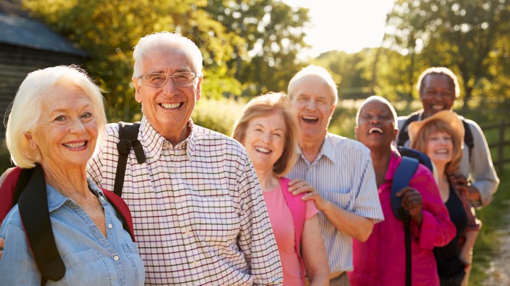 23593568-portrait-of-senior-friends-hiking-in-countryside_1920_1080