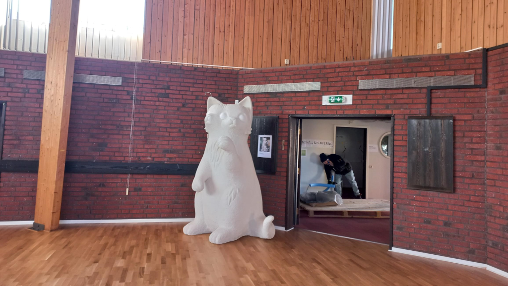 Stor skulptur på en vit katt.